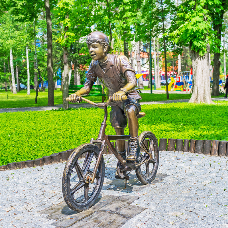 Life size boy riding a bike sculpture (1)