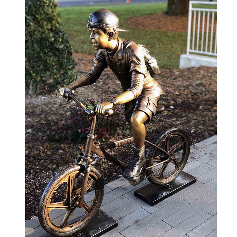 Life size boy riding a bike sculpture (2)