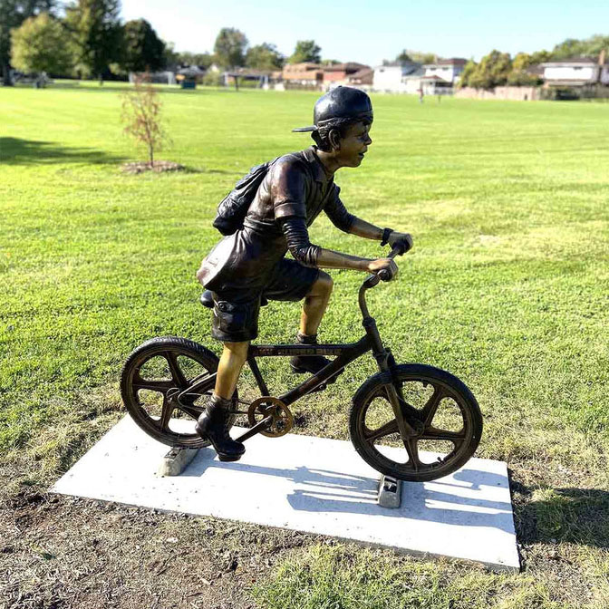 Life size boy riding a bike sculpture (3)