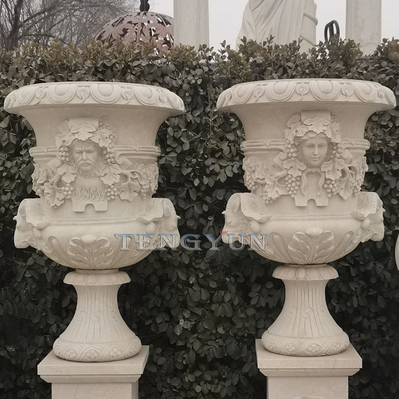 Pair of large size stone marble flower pots with male and femle head carvings (1)