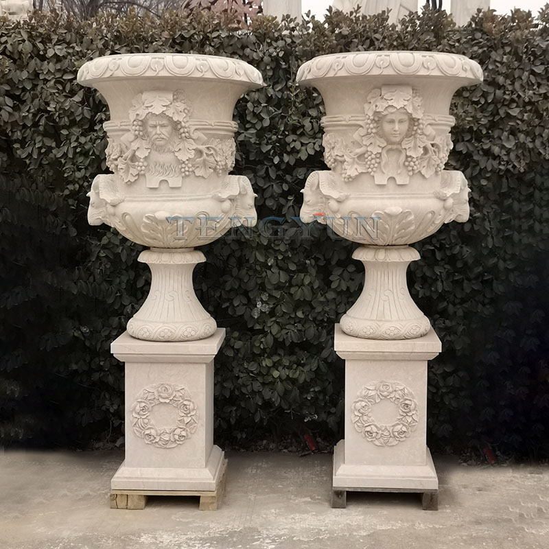 Pair of large size stone marble flower pots with male and femle head carvings (2)