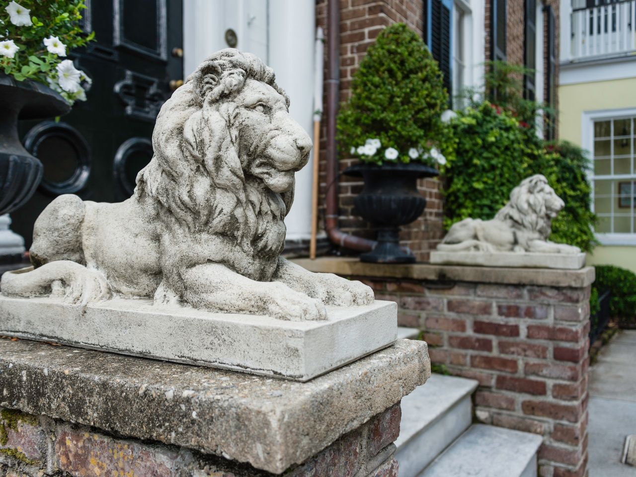 Lions guarding the entrance of historic William C. Bee House in the residential old town neighborhood of Charleston, South Carolina. It is named after William C. Bee, a local historic figure. Published Credit: Getty Images