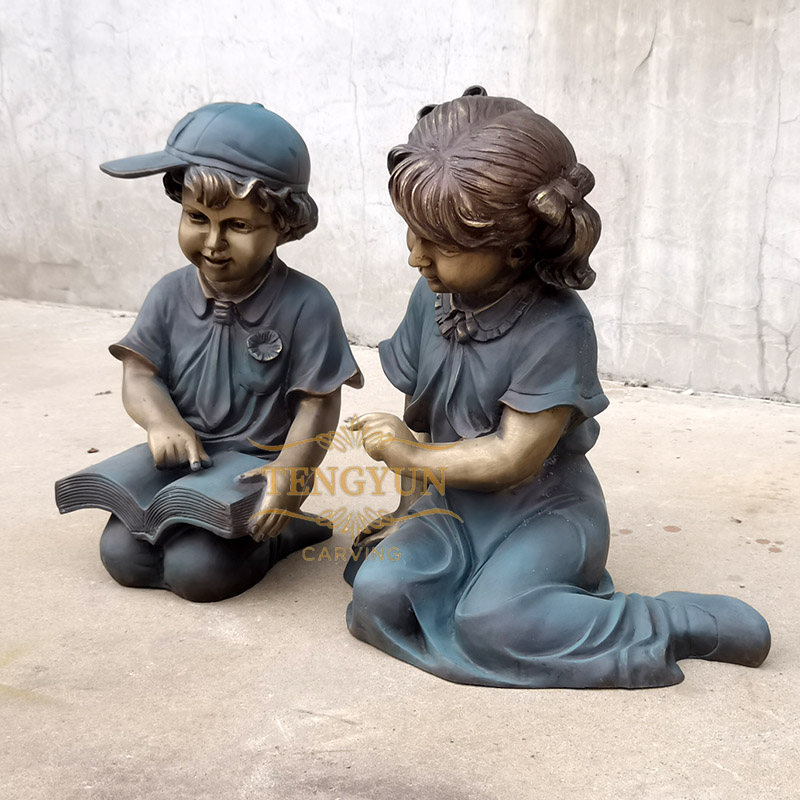 bronze boy and girl children reading statue (1)