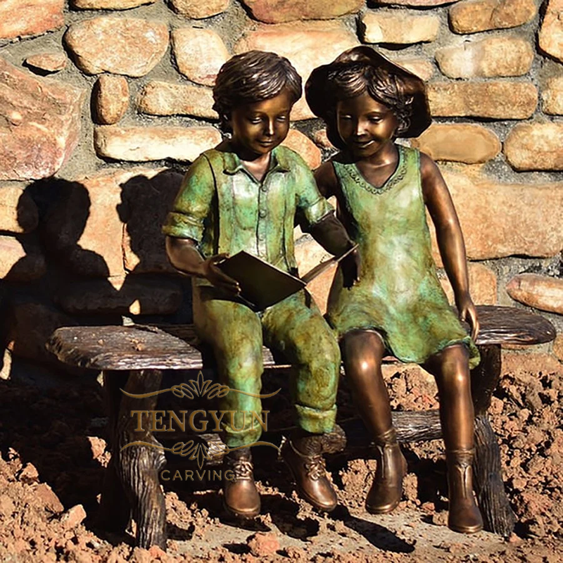 bronze boy and girl sitting on bench reading sculpture (1)