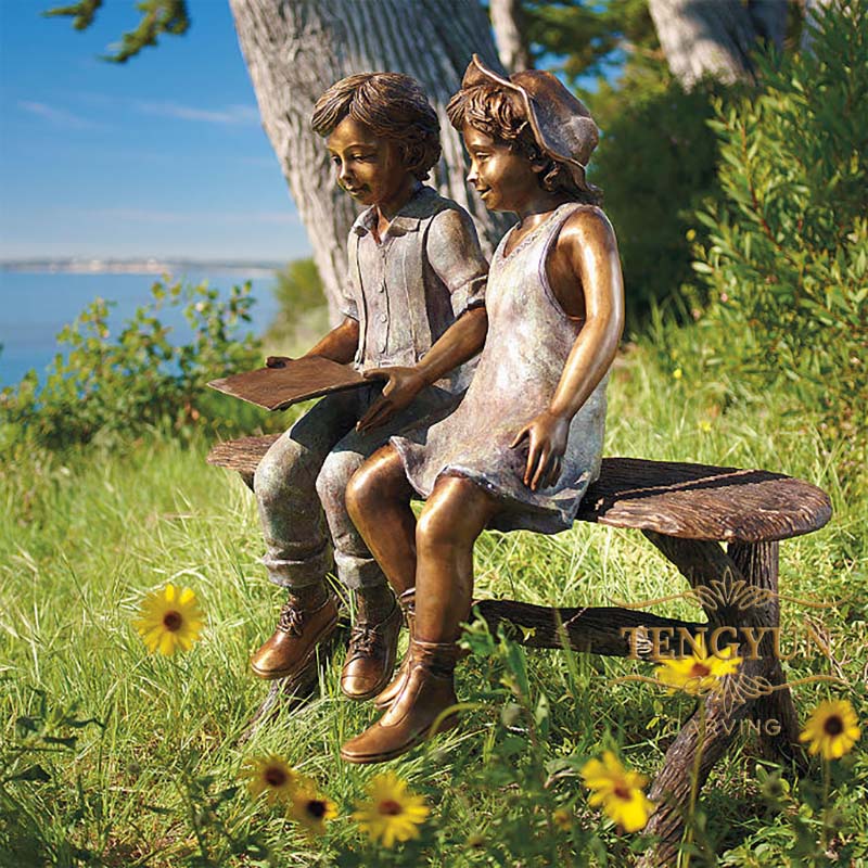 bronze boy and girl sitting on bench reading sculpture (2)