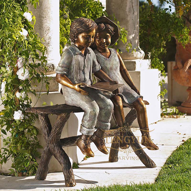 bronze boy and girl sitting on bench reading sculpture (3)