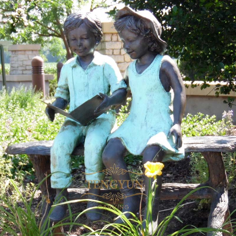 bronze boy and girl sitting on bench reading sculpture (4)