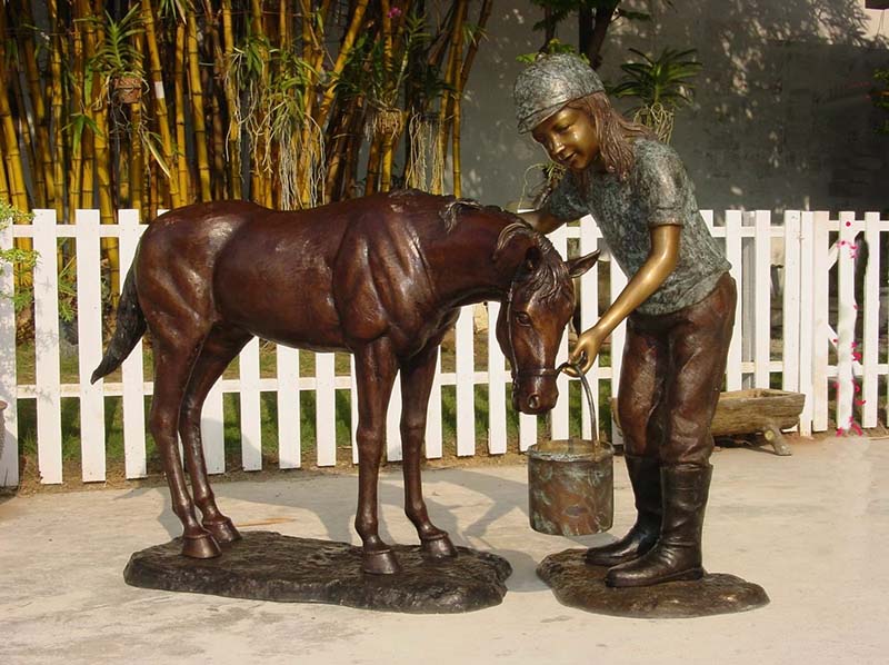 bronze little girl feeding a horse sculpture